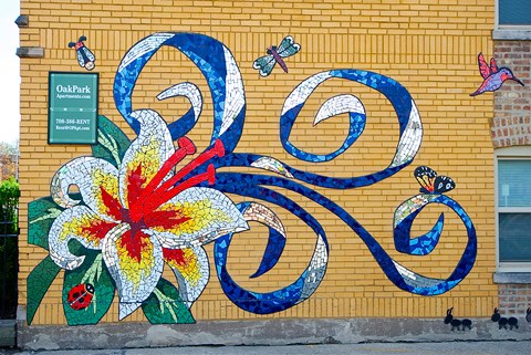 a mural of a flower and butterflies on a brick wall