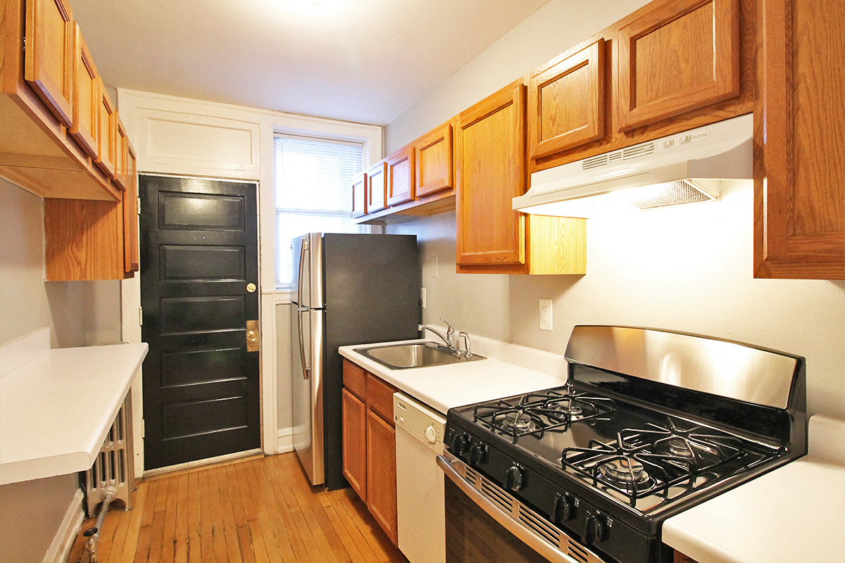 a kitchen with a stove and a sink and a refrigerator