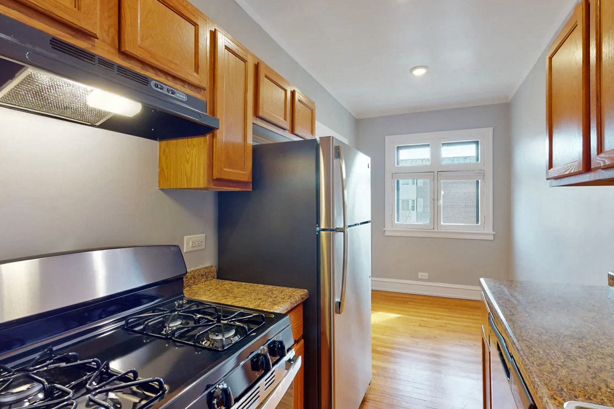 a kitchen with stainless steel appliances and wooden cabinets