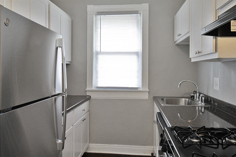a kitchen with a stove and a sink and a refrigerator
