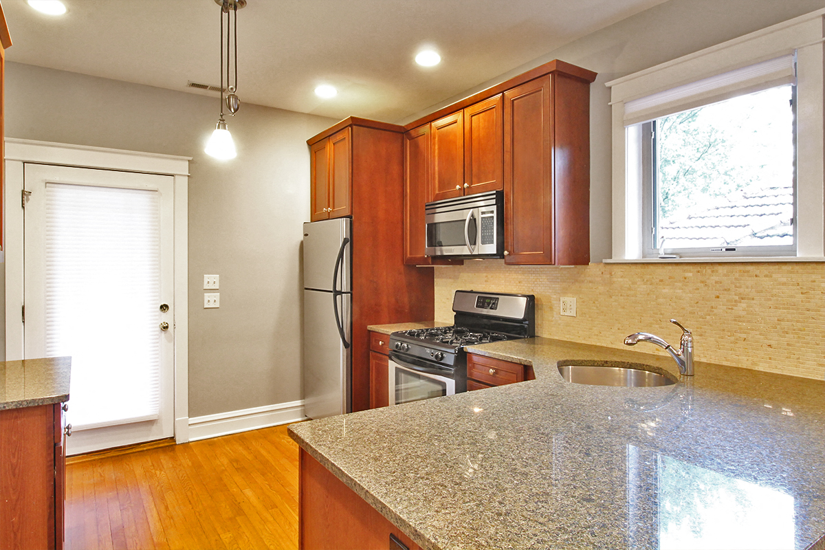 a kitchen with granite counter top and stainless steel appliances
