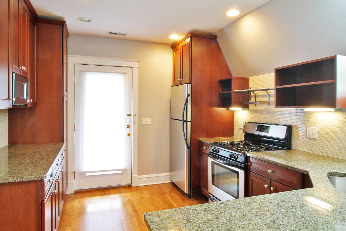 a kitchen with a stove and a refrigerator