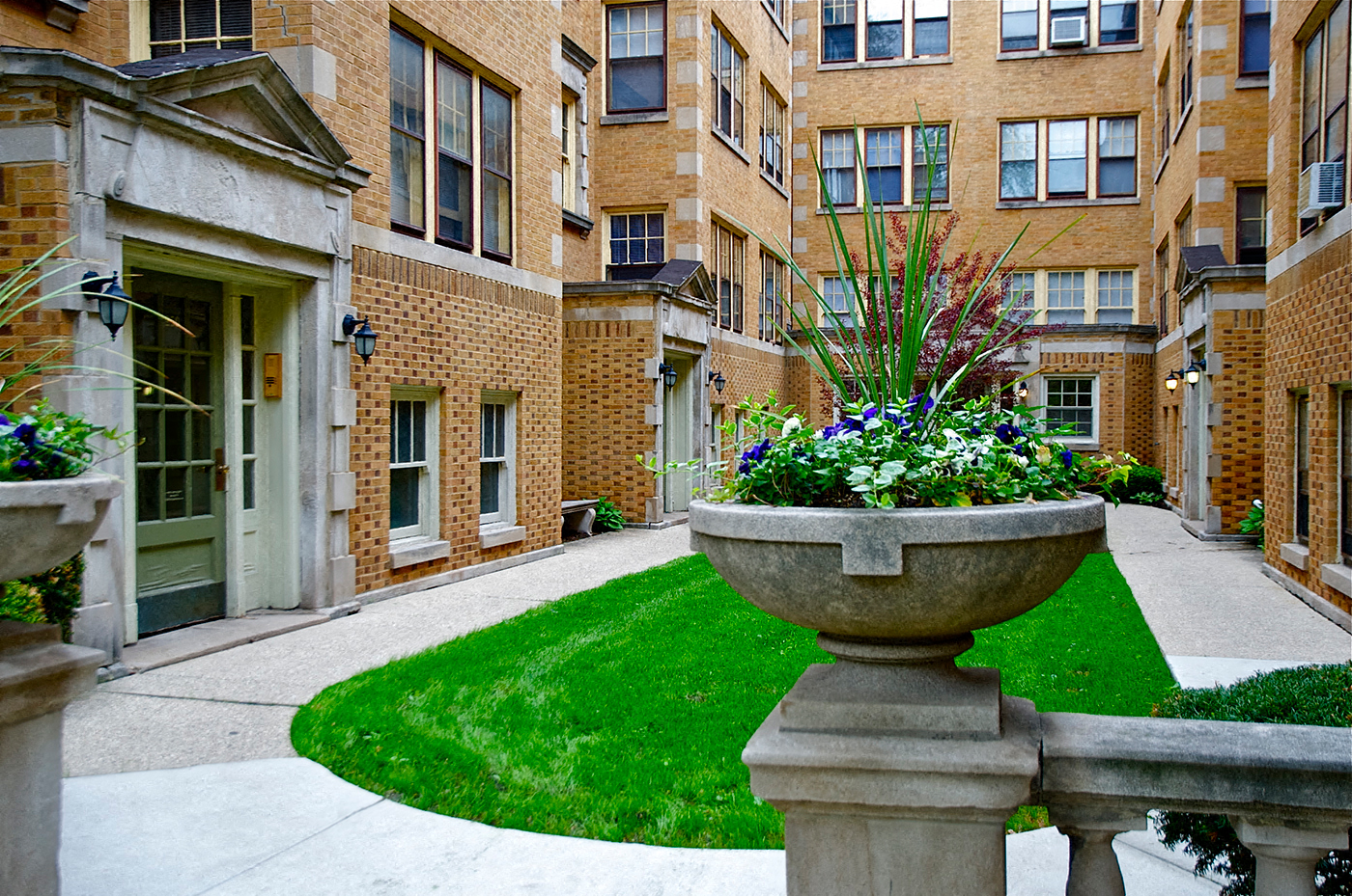 a courtyard with a flower pot in front of a building