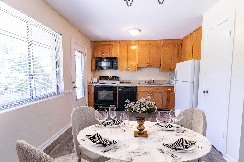 a kitchen and dining room with a table and chairs