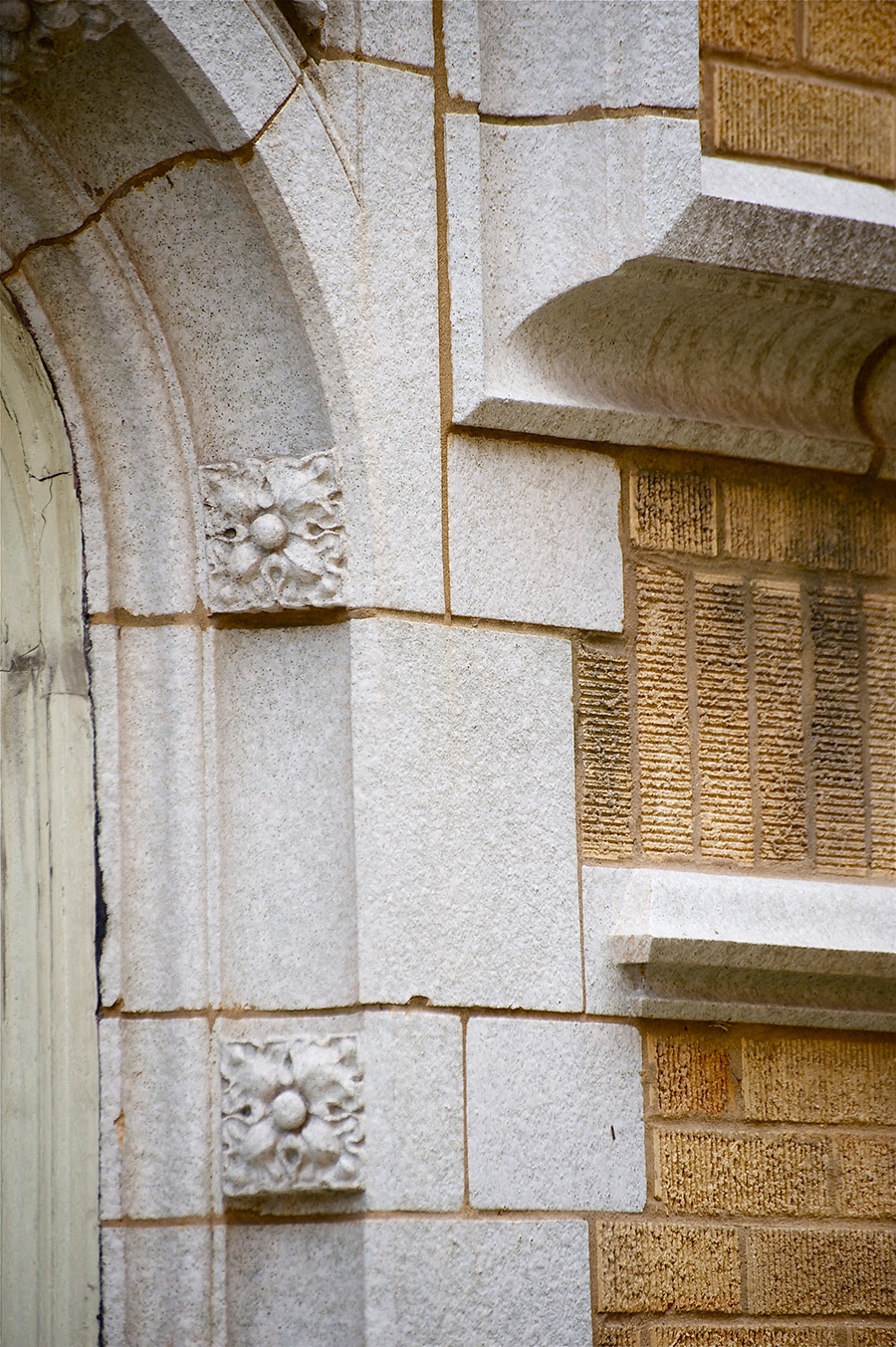 a stone building with an arched door and a window