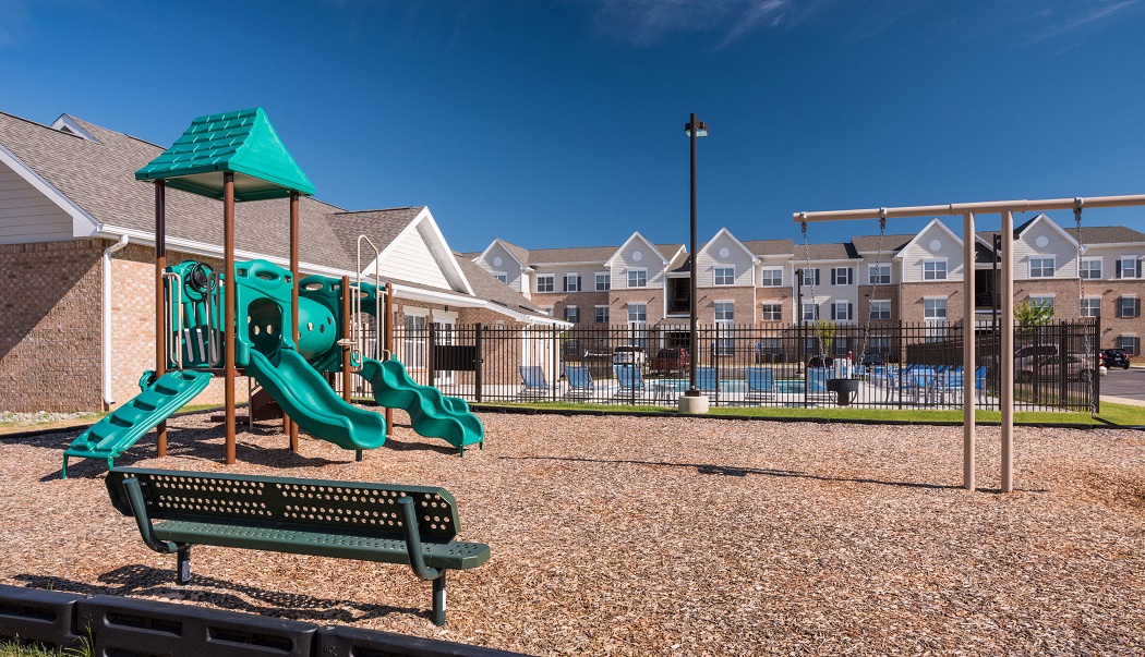 our apartments have a playground with swings and a picnic table