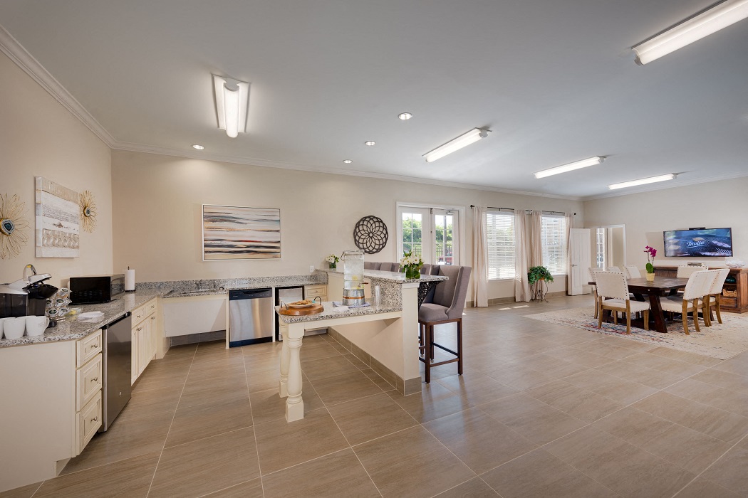 a kitchen and living room with a dining area and a table
