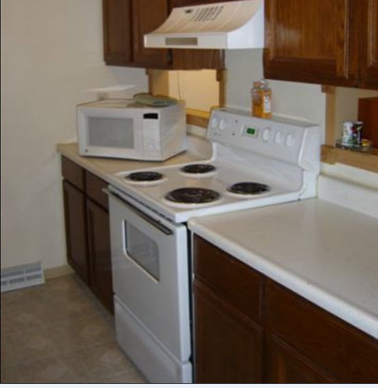 a kitchen with a stove and a microwave
