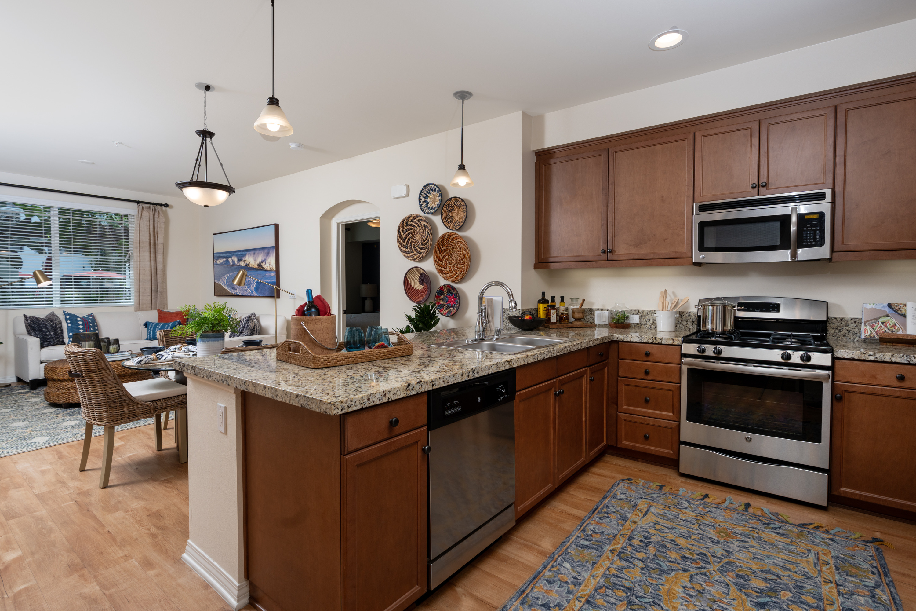 A kitchen with wooden cabinets and a granite countertop.