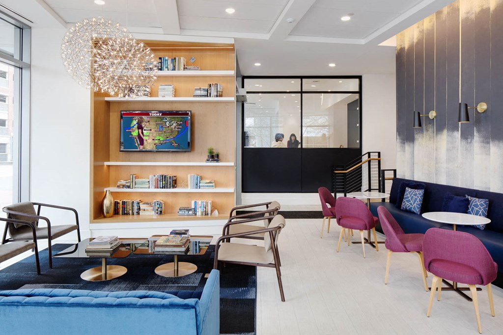 a lobby with a blue couch and chairs