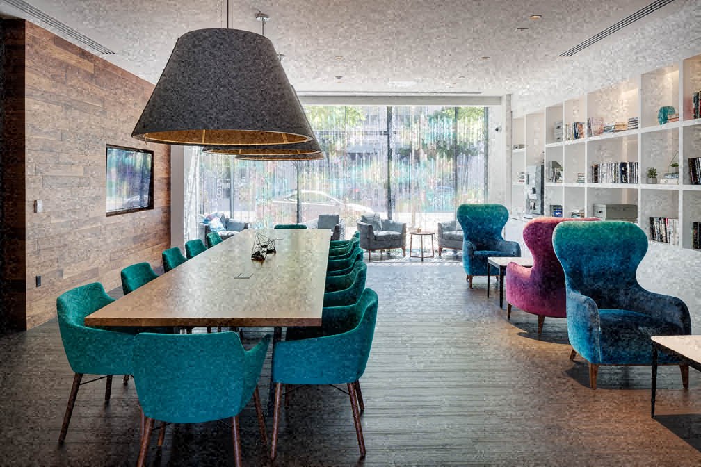 a dining room with chairs and a table and a large lamp