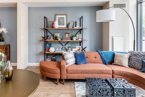 a living room with a orange couch and a table