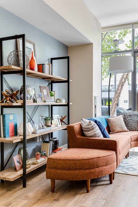 a living room with a couch and a book shelf