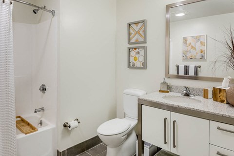 a bathroom with a toilet and a sink and a shower