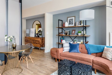 a living room with a couch and a dining table