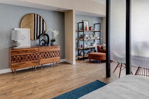 a living room with a dresser and a mirror