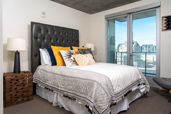 Studio Apartments in San Francisco CA - Etta - Bedroom with Plush Carpeting and Includes a Juliet Balcony that Overlooks the City - Photo Gallery 17
