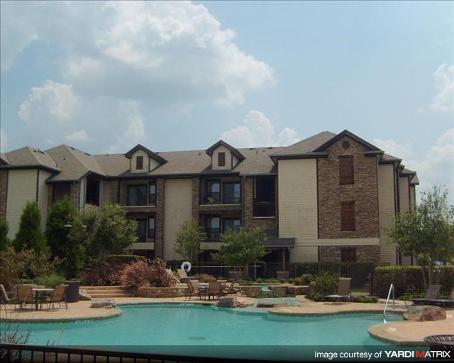 a large swimming pool in front of a building