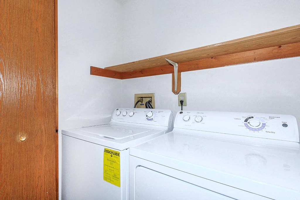 a laundry room with two washes and a dryer
