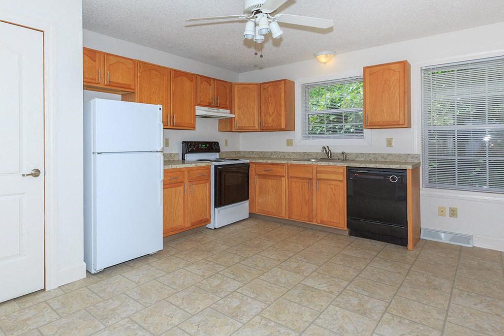 a kitchen with wooden cabinets and a white refrigerator
