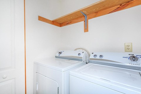 a laundry room with two washes and a dryer
