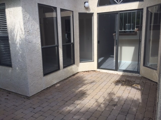 the entrance to a building with a brick patio