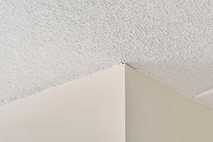 an empty bedroom with white walls and wood flooring and a closet