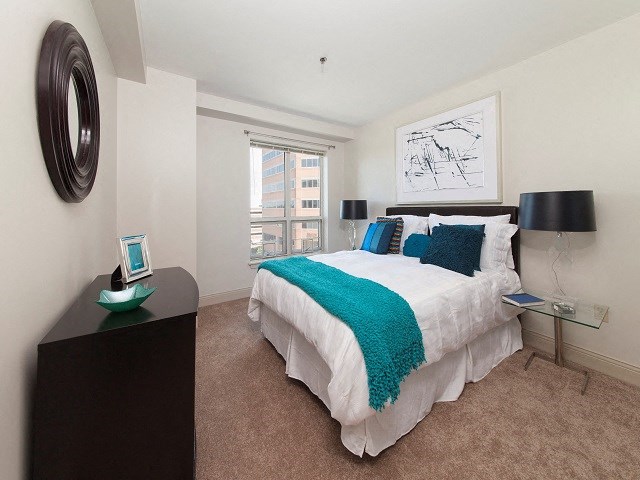 a bedroom with a bed and a window