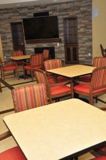 a dining room with tables and chairs and a fireplace