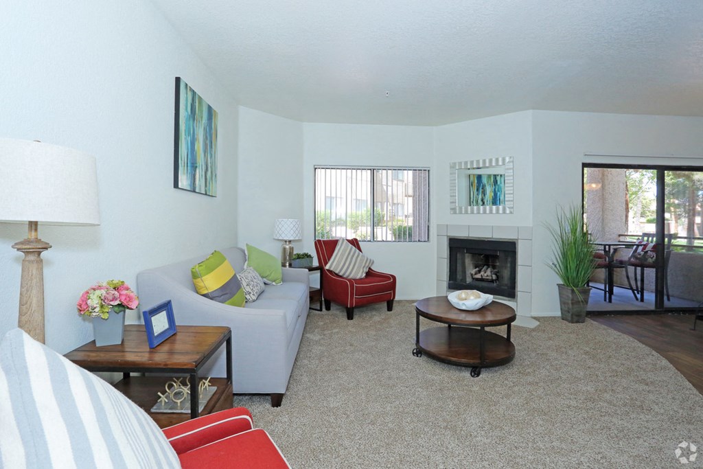 a living room with a couch and a chair and a fireplace