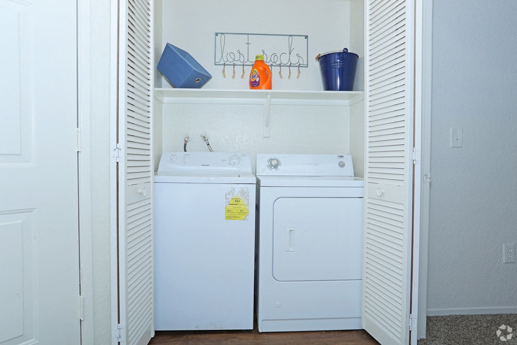 a laundry room with two washes and a dryer