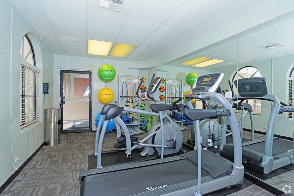 a gym with a lot of machines and weights