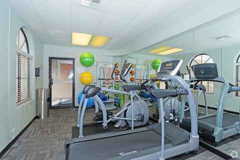 a gym with a lot of machines and weights