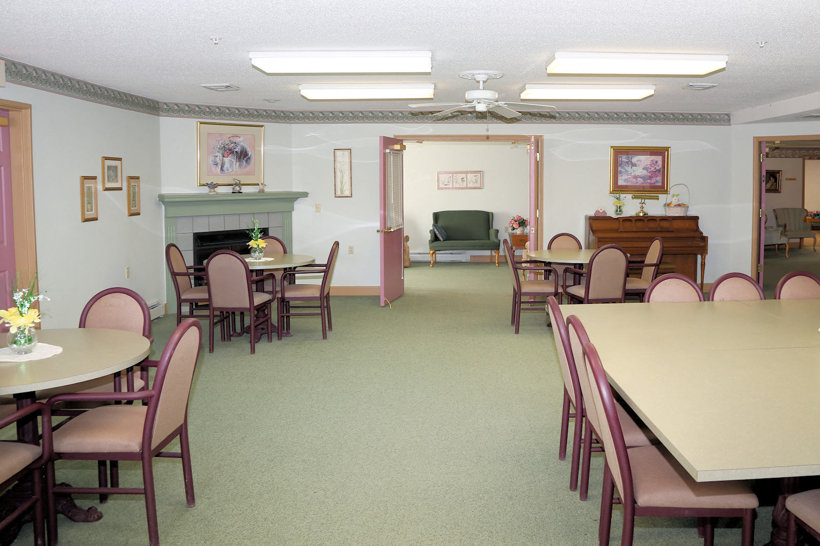a dining room with tables and chairs and a fireplace