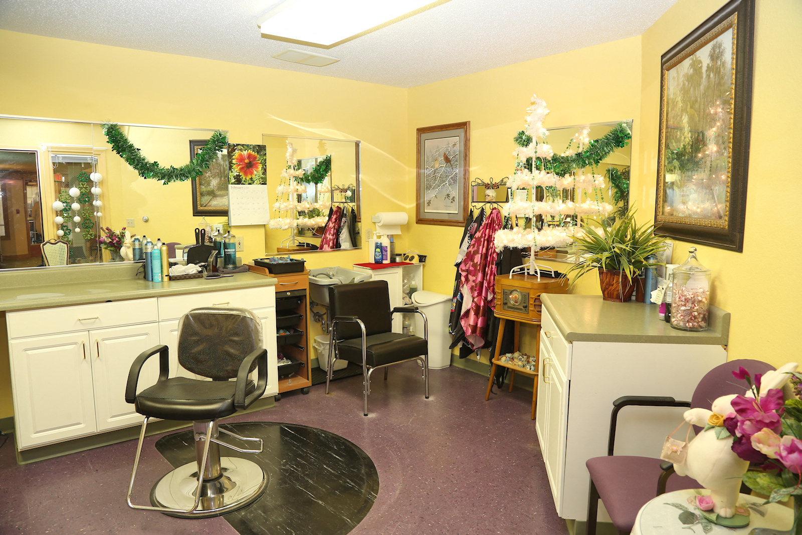 a barbershop with chairs and a counter in a yellow room