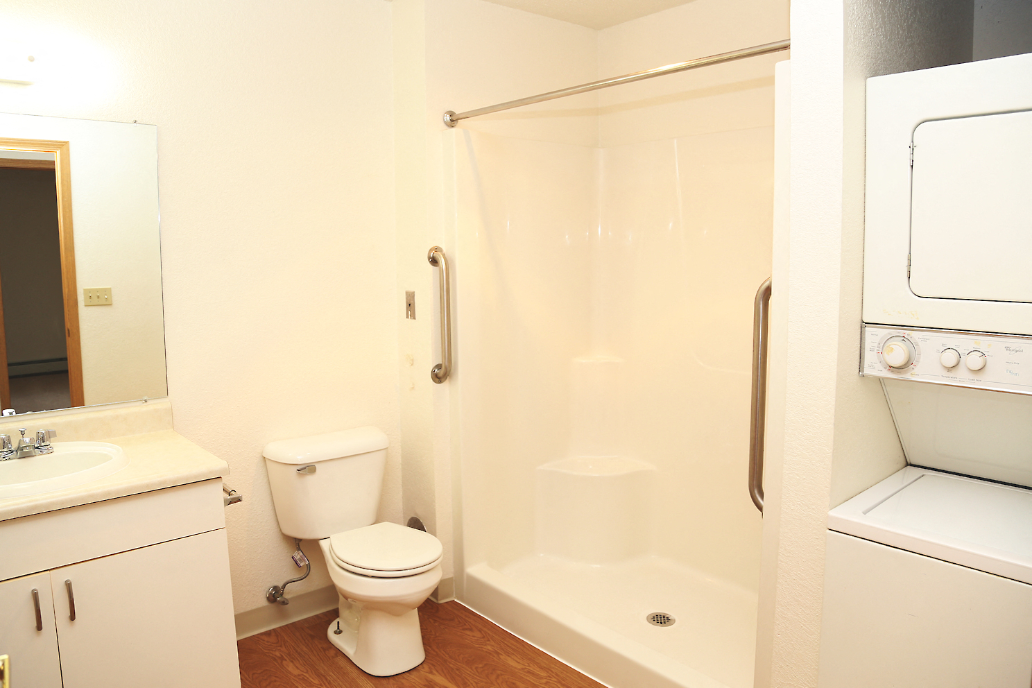 a bathroom with a toilet and a shower and a sink