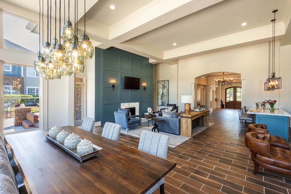 a large living room with a wooden table and chairs