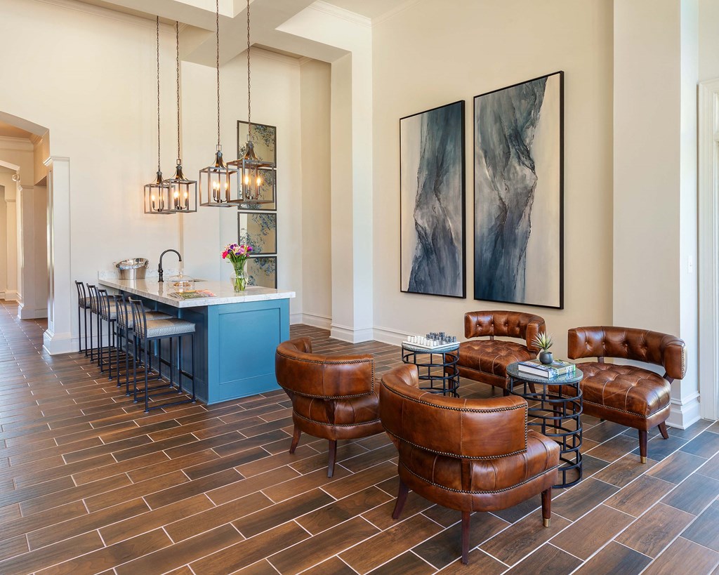 a living room with leather chairs and a bar