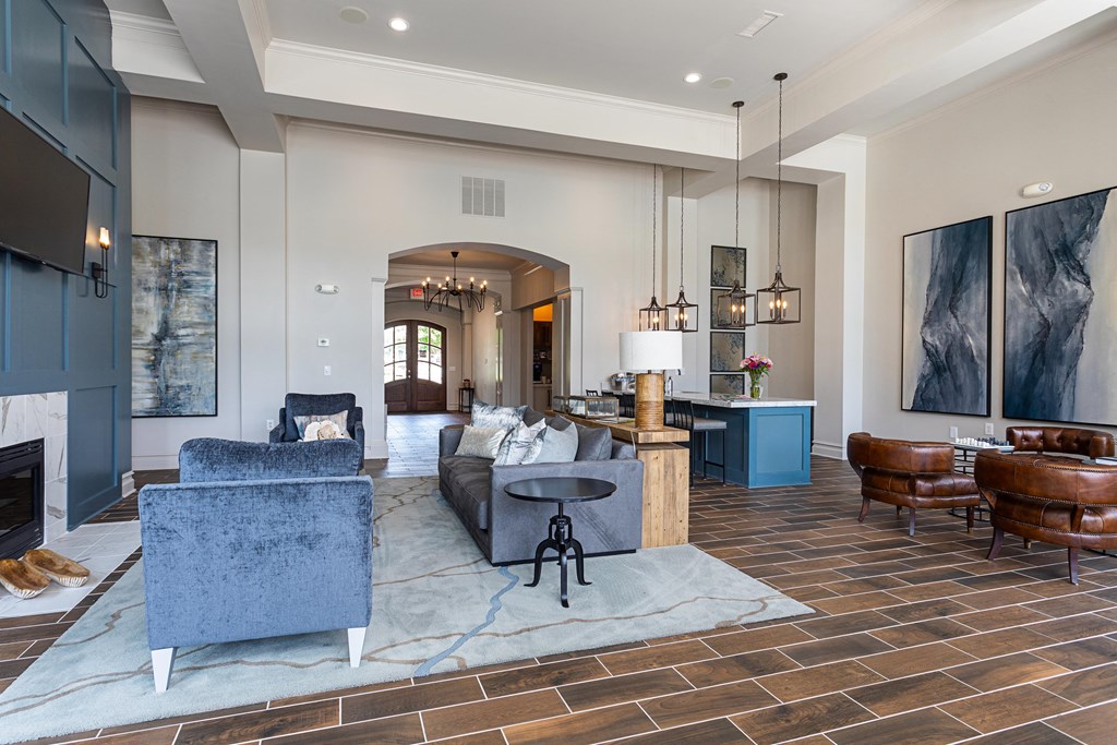 a living room with couches and chairs and a fireplace