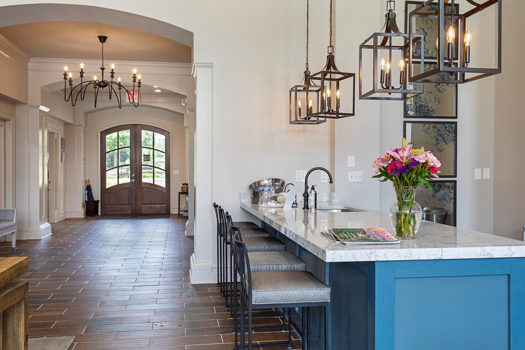 a large kitchen with a blue island and chairs