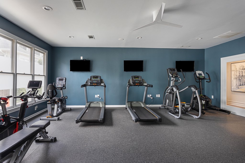 a gym with treadmills and other exercise equipment