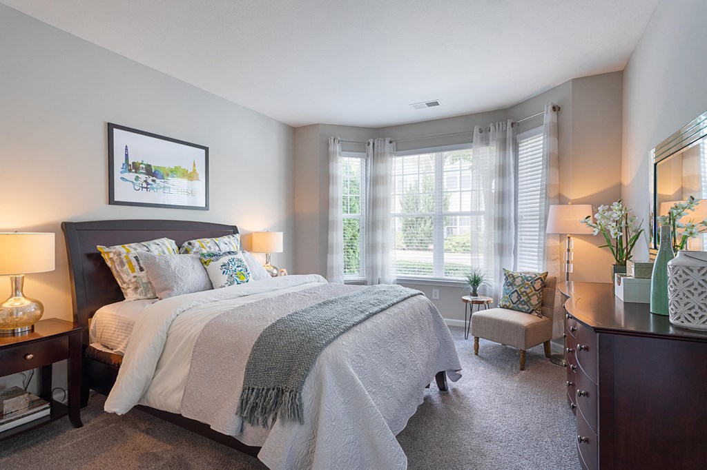 a bedroom with a large bed and a window