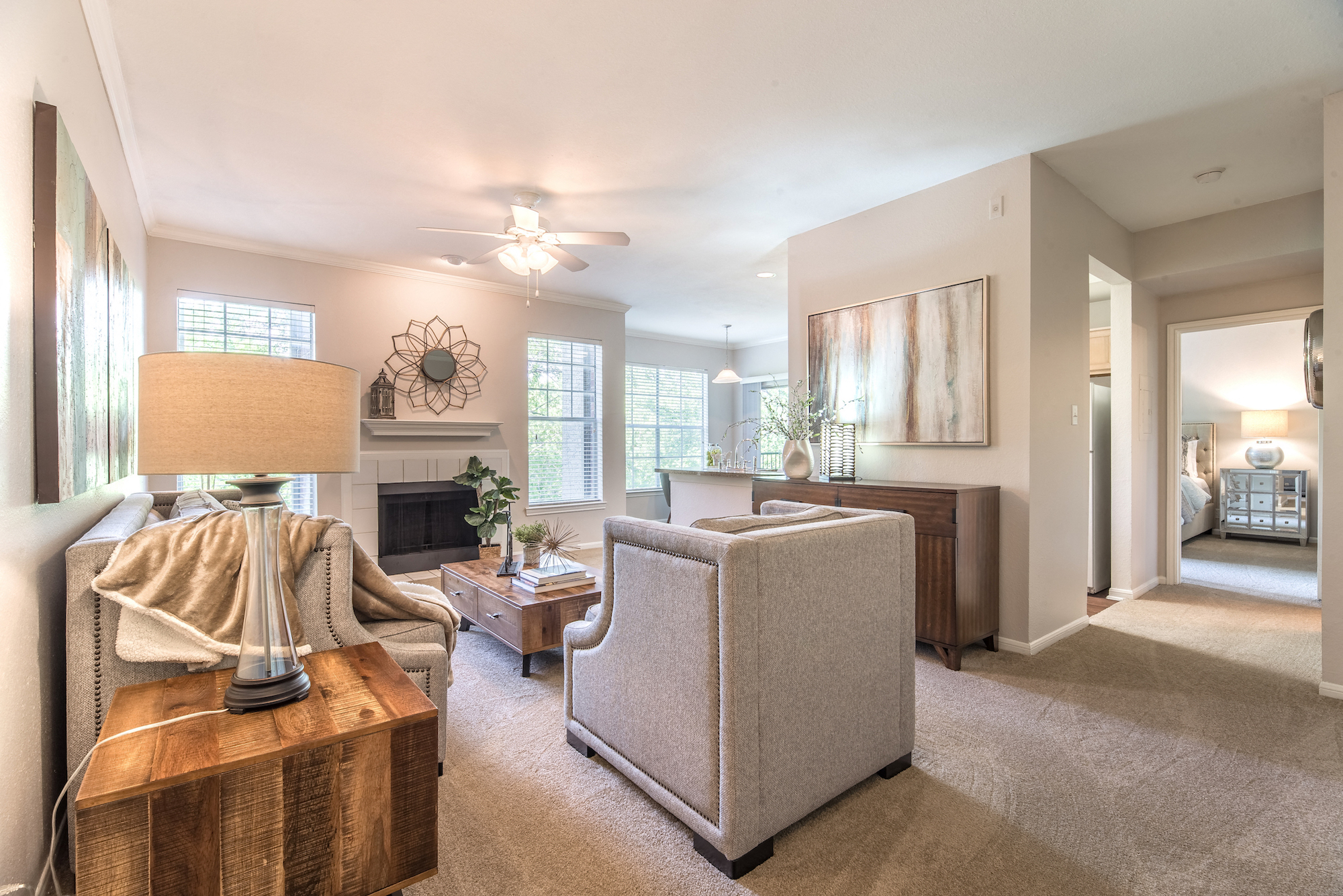 a living room with a couch and a chair and a fireplace