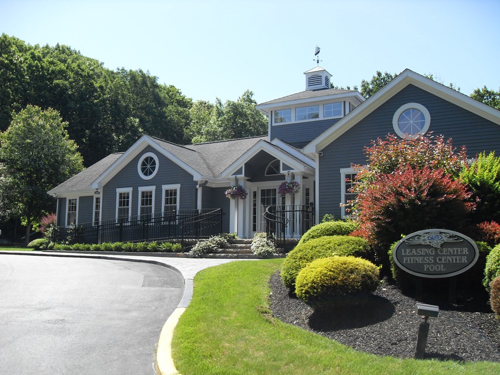 a house with a driveway and a sign in front of it