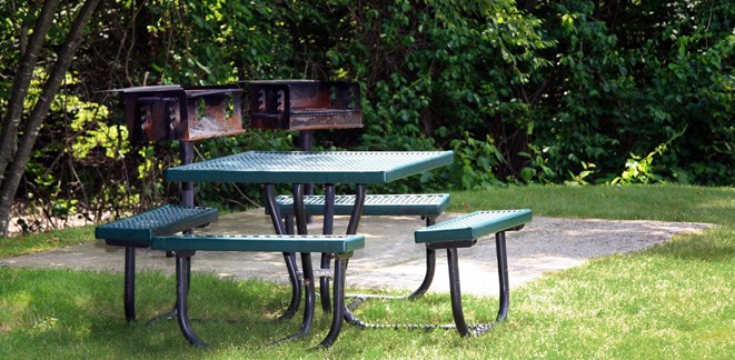 a picnic table and benches in a park