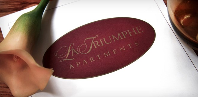 the logo is printed on a piece of red paper on a table with a bottle