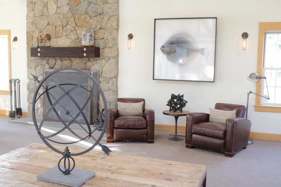 a living room with chairs and a fireplace