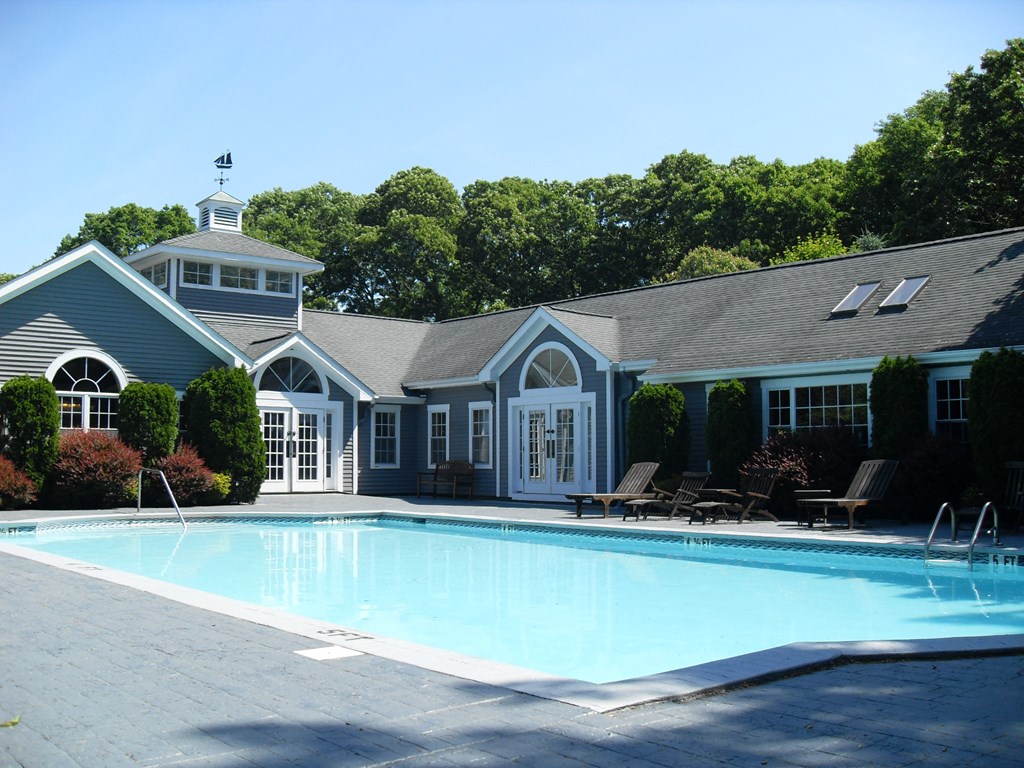 a swimming pool in front of a house