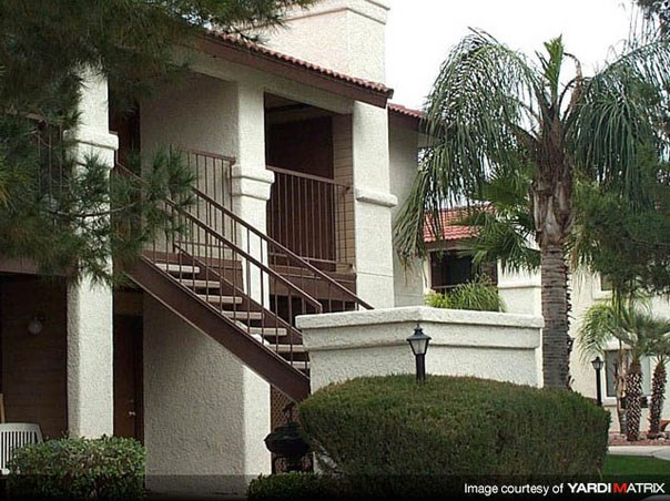 a house with a staircase and a palm tree