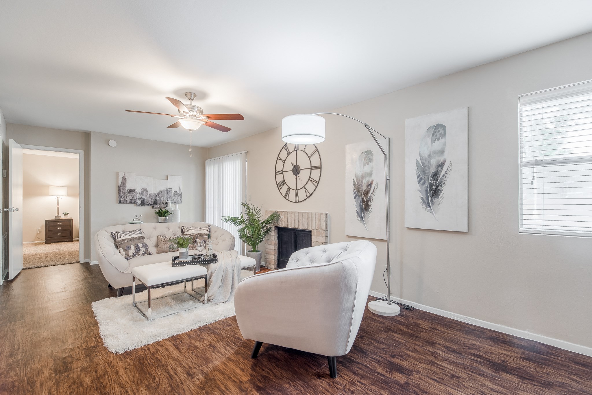 a living room with a couch and a chair and a fireplace